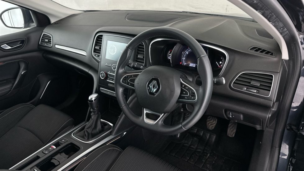 Right-hand-drive Renault Mégane interior showing the dashboard and front seats